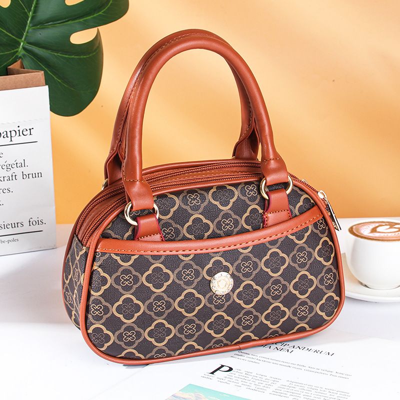 La nuova moda primaverile ed estiva da donna porta a mano la piccola borsa da donna la tendenza della borsa per cellulare con moneta per la spesa tenuta in mano dalla mamma_voghion.com