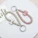 Dámský lehký luxusní hliněný diamantový přívěsek na klíče s mašlí, proti ztracení diamantového prstenu, přívěsek na klíče, náramek s diamantovým přívěskem na mobilní telefon_voghion.com