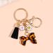 Porte-clés avec pompon et nœud papillon imprimé léopard, nouvelle mode, mignon, pendentif pour sac_voghion.com