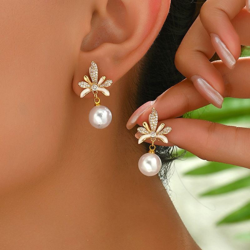 Unique women's with versatile high-end design featuring coconut leaves, diamond studded string, pearl earr, and_voghion.com