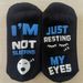 Unisex Black and white dotted eyelashes sleeping face socks i'm not sleeping just resting_voghion.com