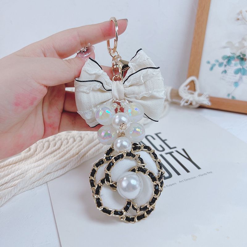 Korean version exaggerated bow, pearl string, leather chain, camellia keychain, women's fashionable bag pendant_voghion.com