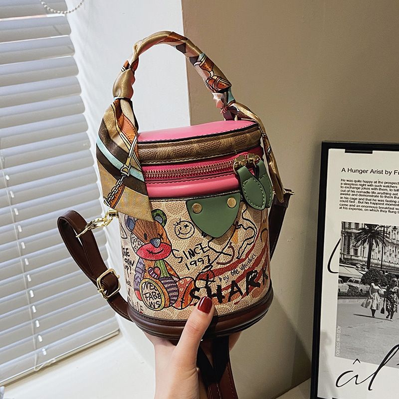 Graffiti bucket in 2024, new fashionable niche cylindrical bag, handheld one shoulder crossbody bag for women_voghion.com