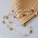 Accessori versatili in acrilico alla moda con perline a goccia d'acqua, tracolla color albicocca, corda appesa, catena per telefono_voghion.com