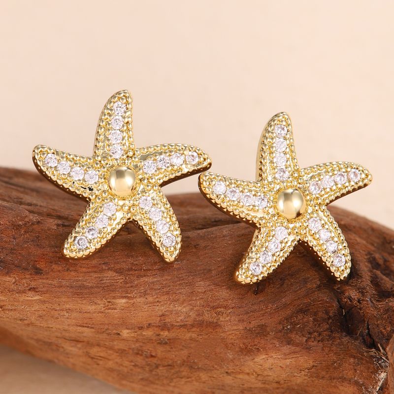 1 paio di orecchini a bottone con strass in rame e intarsi a forma di stella marina casual_voghion.com