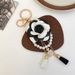 Portachiavi per auto con bottiglia di profumo in filo di perle di camelia bianca e nera, stile coreano, ciondolo per borsa da donna, piccolo_voghion.com