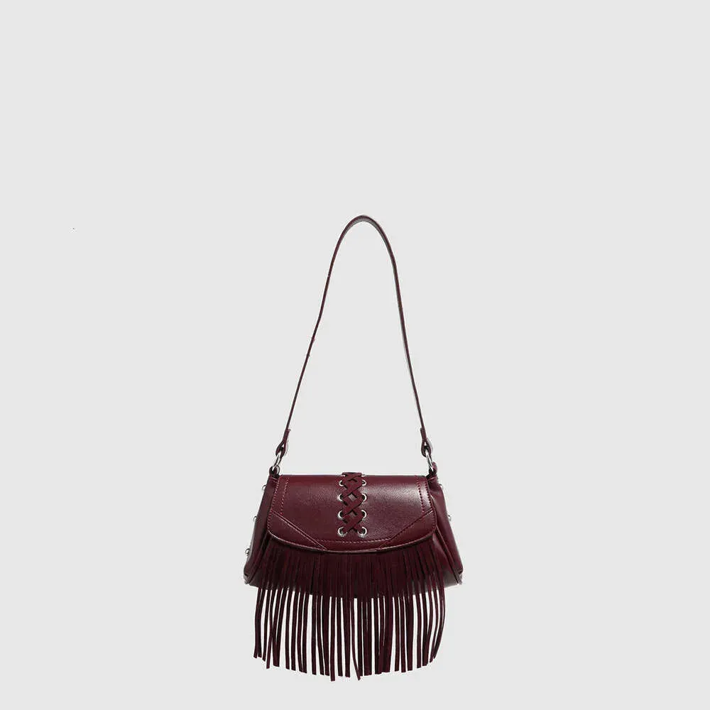 2025 New Rivet Hollow Single Shoulder Handbag Magnetic Buckle Tassel Saddle Zipper Pleated Women's Bag_voghion.com