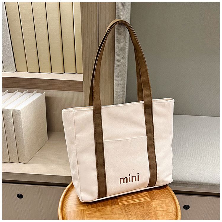 Bolsa de lona moderna transfronteiriça para estudantes universitários do sexo feminino estilo coreano bolsa de ombro casual grande capacidade simples carta bolsa de mão_voghion.com