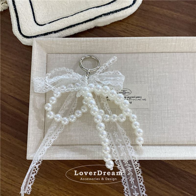Väska delar & tillbehör Nischdesign Pärlspets rosett hänge Fashionabla high end textur väska Bilnyckelring hänge_voghion.com
