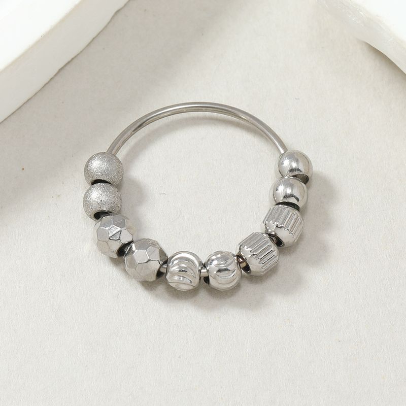 Roestvrijstalen sieraden met tien beweegbare, gematteerde ballen om angst en stress te verlichten. Titanium stalen ringfabriek_voghion.com