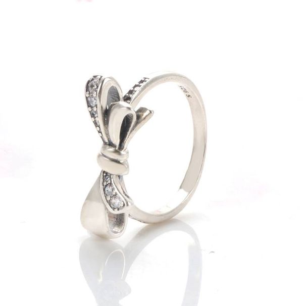 Anillo elegante de lazo con circonitas para mujer, de aleación de cobre plateada, ideal para San Valentín, cumpleaños y como accesorio de moda._voghion.com