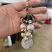 Exquisite diamond studded round pearl string small fragrance keychain clothes 5-character metal decoration bag pendant_voghion.com