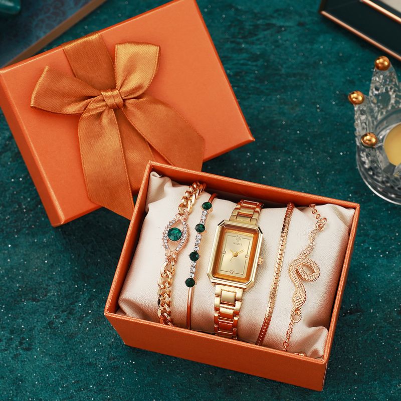 Sieviešu pulksteņu un rotaslietu komplekts ar kvadrātveida tērauda joslu, tirkīza krāsas rhinestones aproci, čūskas acs aproci, dāvanu_voghion.com