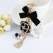 Korean Creative New Drip Oil Mountain Camellia Keychain Exquisite Bow Pearl Chain Bag Hanging Accessories_voghion.com