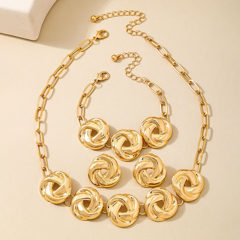 Set di gioielli da donna alla moda, design coordinato, in metallo, motivo geometrico a spirale in oro, collana, bracciale e orecchini._voghion.com