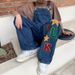 Hiphop-handduksbroderad denimryggband för män och kvinnor hösten 2023 nya lösa raka Halen-byxor med vida ben_voghion.com