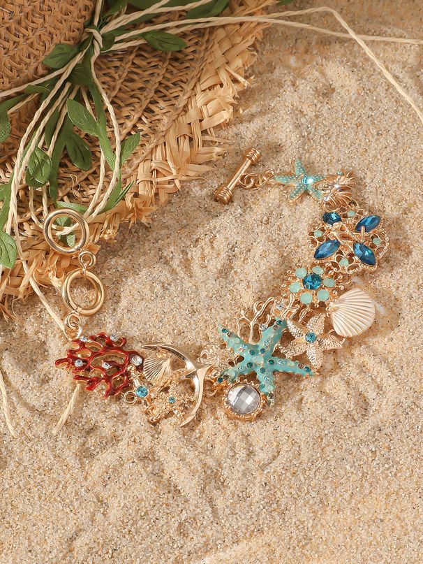 Pulseira Cayi Bohemian Ocean Element com pingente de cobre e metal incrustado em concha de coral e estrela do mar_voghion.com