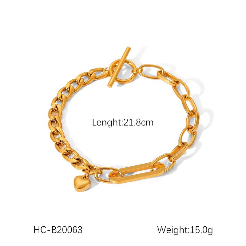 Bracciale con catena ovale cubana in acciaio inossidabile INS con ciondolo a forma di cuore e fibbia OT per donna, in acciaio e titanio dorato._voghion.com