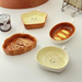 Piatto piccolo in ceramica con testa di pane, simpatico cartone animato, con sapore creativo, per spuntini casalinghi, con salsa di condimento colorata sotto smalto._voghion.com