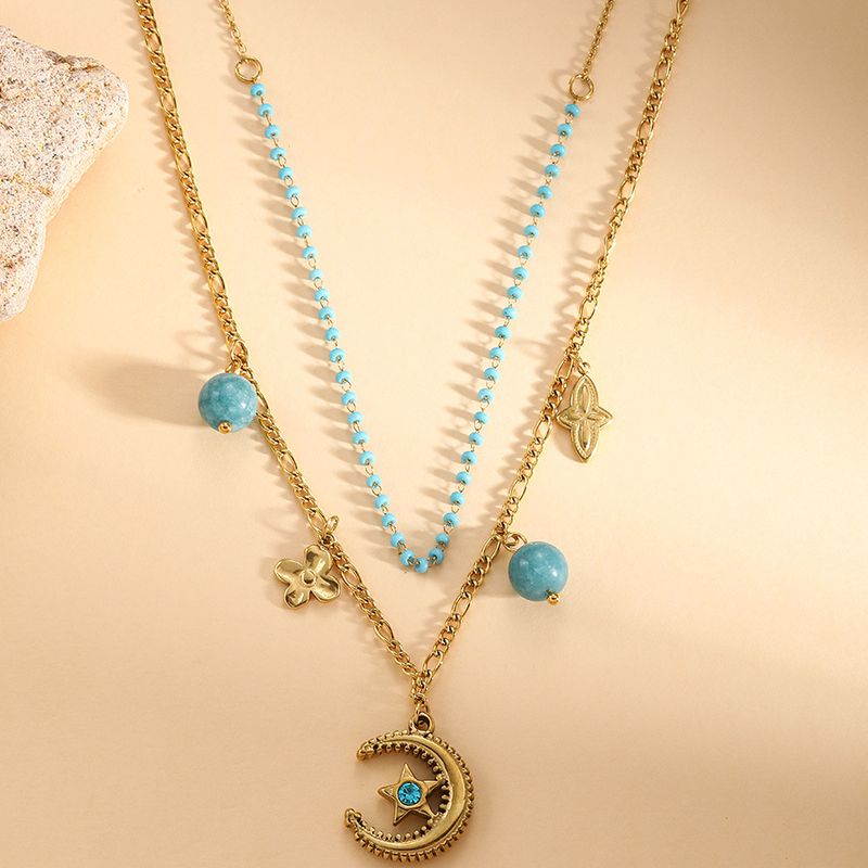 Collana con doppio strato sovrapposto dal design di nicchia, pendente a forma di stella e luna, collana in acciaio al titanio con perline blu e conchiglia bianca._voghion.com