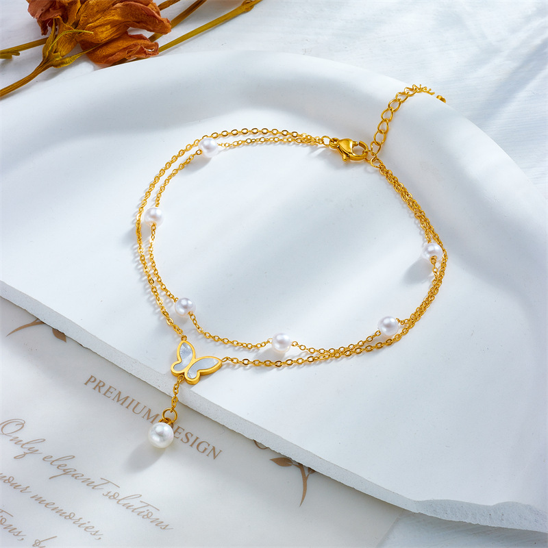 Style coréen tempérament de mode élégant luxe léger multicouche empilable perle papillon gland chaîne titane acier polyvalent bracelet de cheville_voghion.com