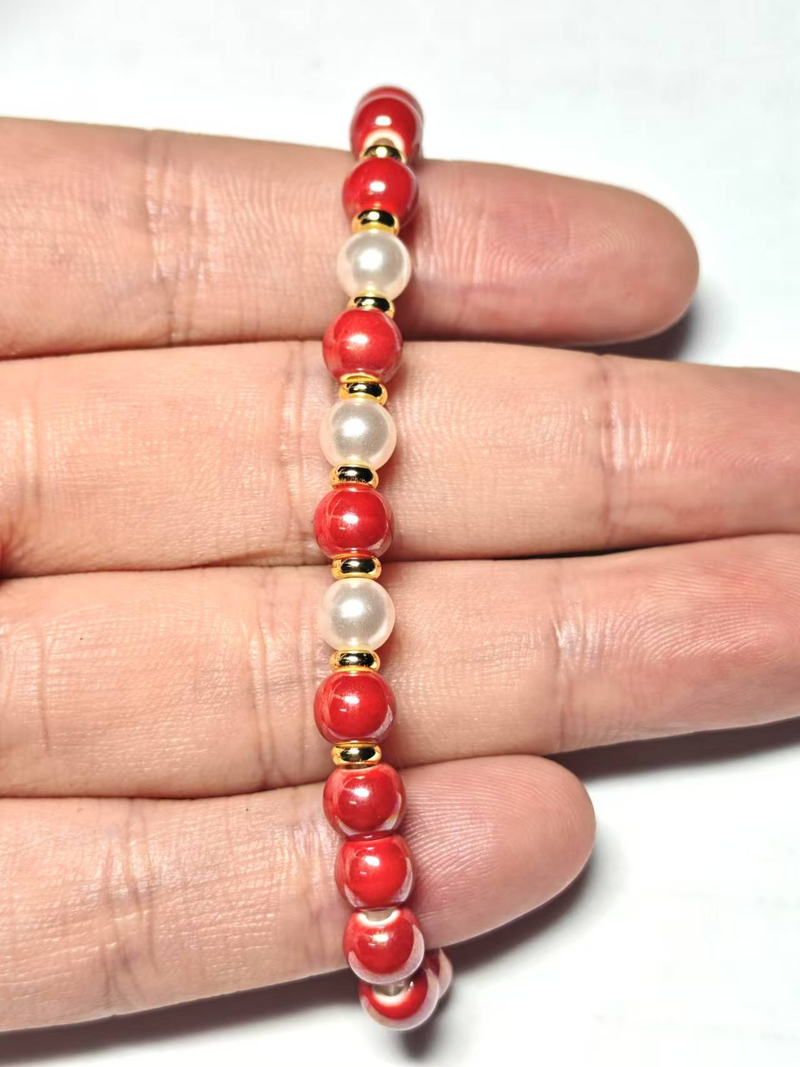 Handgefertigtes Keramikarmband aus Jingdezhen: Kunsthandwerklich gefertigt mit leuchtend orangefarbenen Perlen, floralen und blau-weißen Akzenten für den täglichen Stil, der lebendiges Flair verleiht_voghion.com