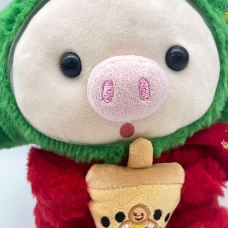 Adorabile peluche a forma di maialino natalizio con disegni di Babbo Natale e renne per una gioia natalizia_voghion.com