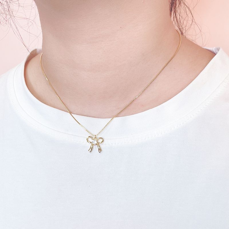 Collana con fiocco alla moda, orecchini con diamanti intarsiati, ciondolo squisito in argento_voghion.com