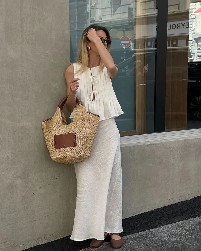 Completo da donna europeo e americano, primavera ed estate 2025, in cotone e lino, senza maniche, due pezzi, con camicia e gonna lunga da donna con spalline sottili._voghion.com