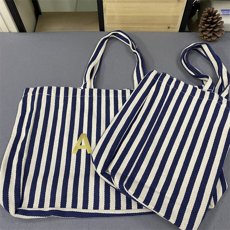 Bolsa de compras unissex de lona com listras verticais Lotte Korea AP_voghion.com