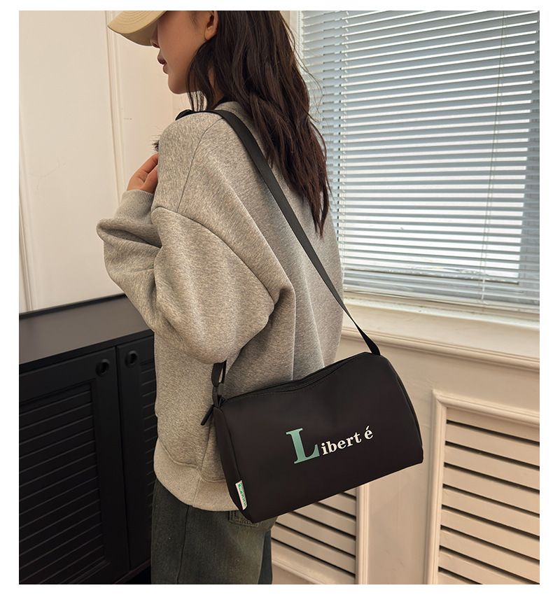 2024 New Casual Shoulder Women's Oxford Cloth Large Capacity Lightweight Pillow Black Minimalist Printed Crossbody Bag_voghion.com