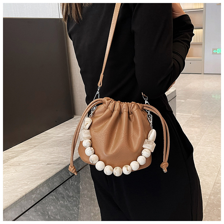 Autumn and winter minority foreign milk candy pearl drawstring fold Korean style advanced sense of light luxury 100 shoulder armpit oblique span bag_voghion.com