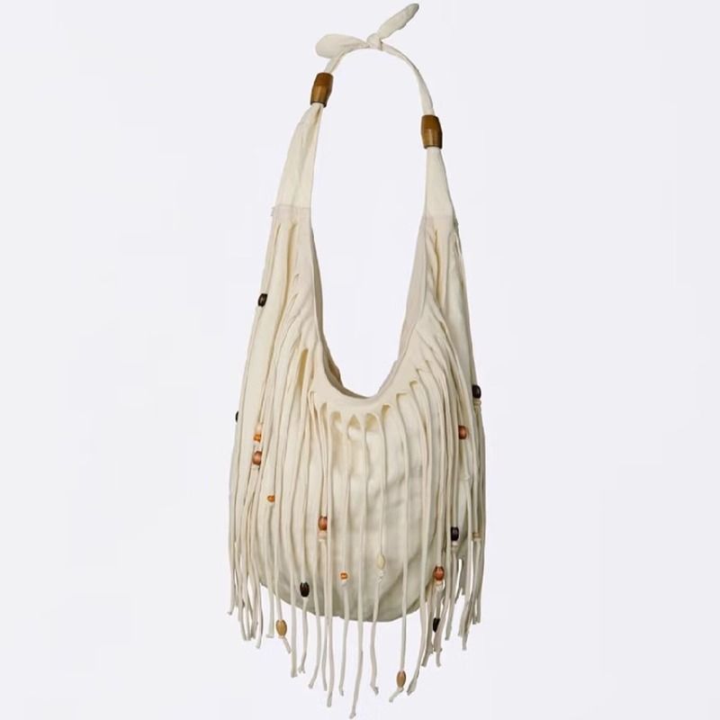 Uma bolsa tote com franjas em estilo boêmio, de designer coreano, especialmente projetada para mulheres, é uma nova bolsa transversal de ombro único para o outono/inverno de 2025._voghion.com