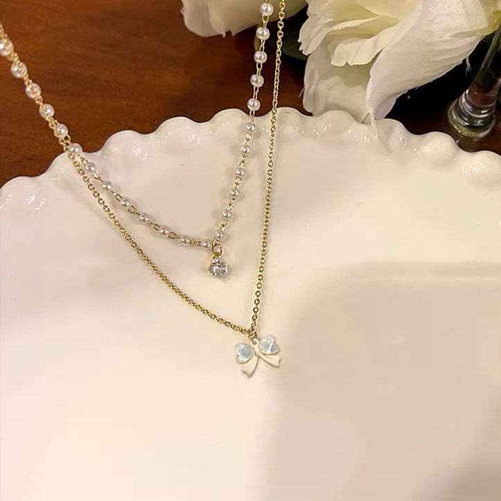 Leichte Luxus-Nischen-Doppelschicht-Perlenkette für Damen, Ins Trend High-End-Design Bowknot-Schlüsselbeinkette_voghion.com