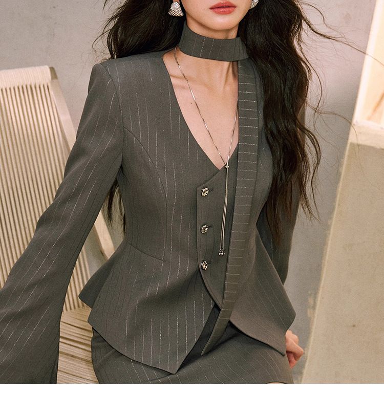 Blazer aderente corto di alta qualità da donna, in seta lucida a righe chiare frantumate, con patta asimmetrica e lungo nastro che stringe la vita_voghion.com