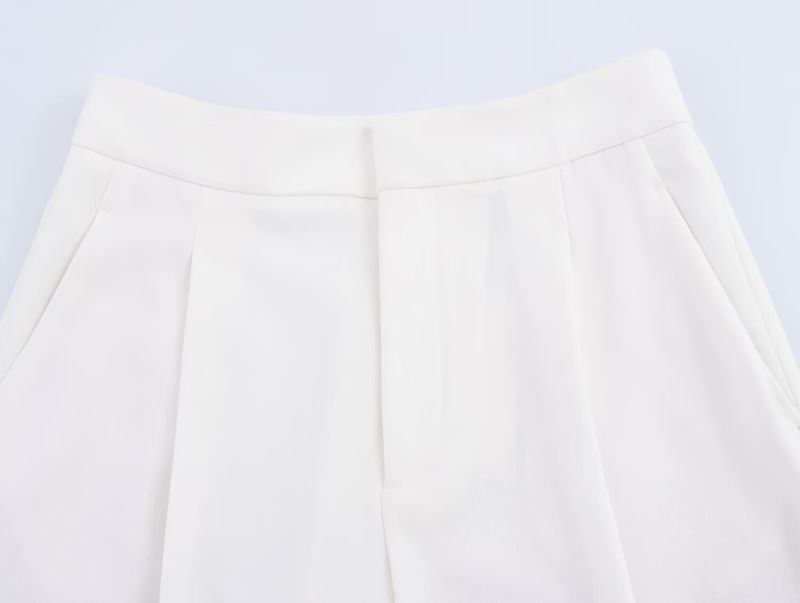 Traje de mujer de moda con chaleco asimétrico sencillo con cuello en V y pantalón ancho plisado._voghion.com
