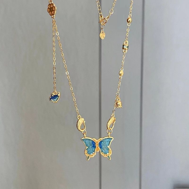 Collana con farfalla blu in smalto blu bruciante color sabbia oro, collana con farfalla sfumata, collana di lusso placcata in oro all'ingrosso_voghion.com