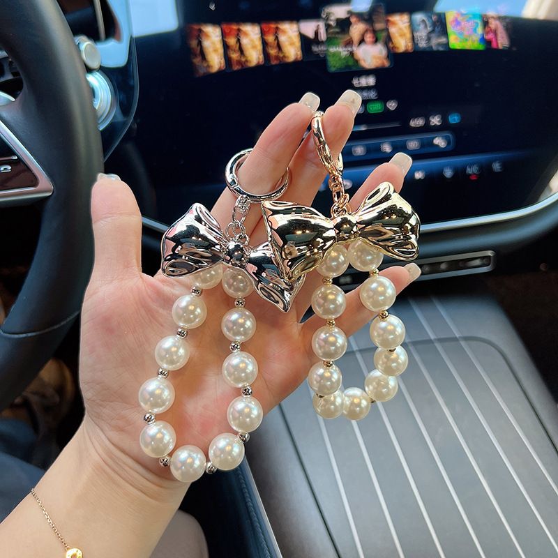 Versione coreana, ciondolo con perline di alta qualità, design di nicchia in oro e argento, papillon, accessori per borse, portachiavi per auto, decorazione_voghion.com