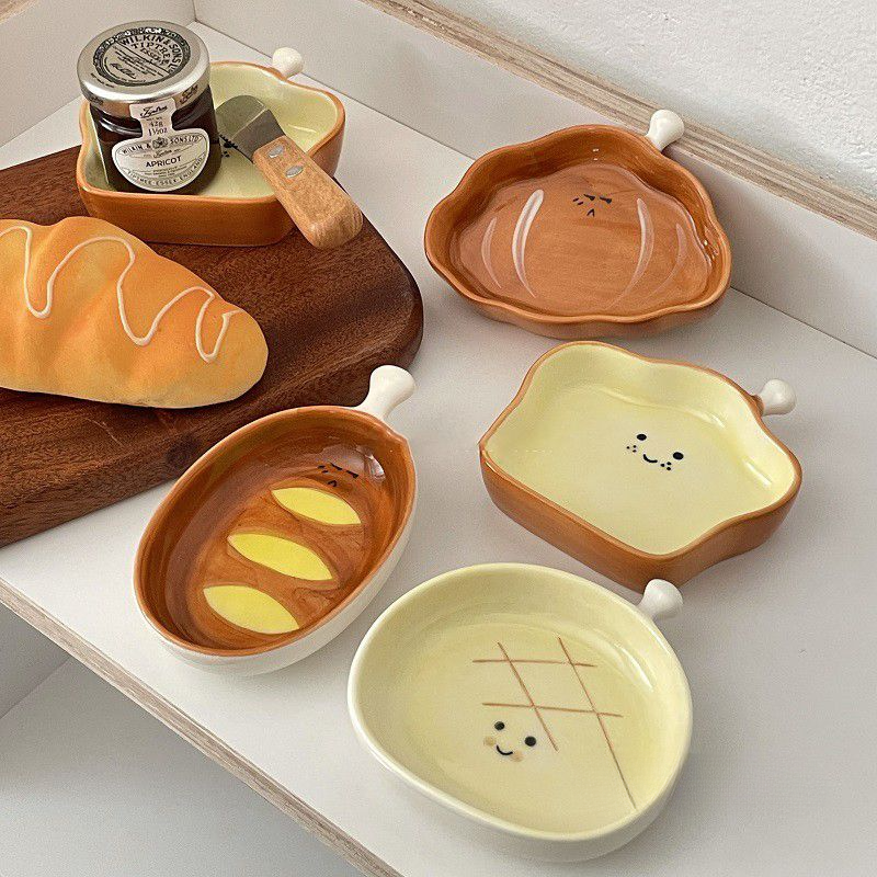 Piatto piccolo in ceramica con testa di pane, simpatico cartone animato, con sapore creativo, per spuntini casalinghi, con salsa di condimento colorata sotto smalto._voghion.com