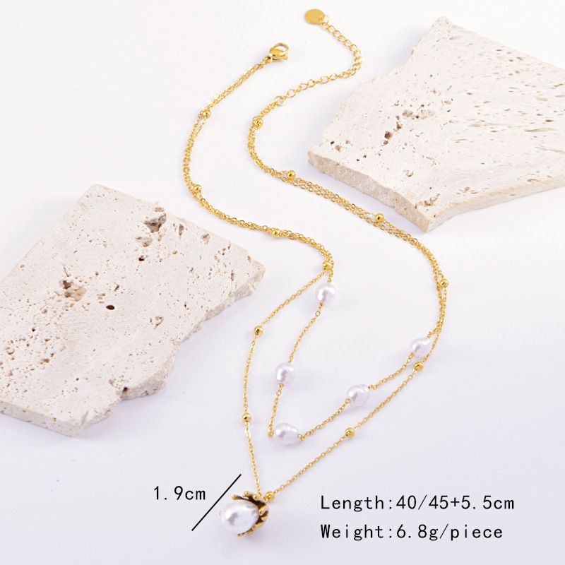 Collana con orecchini e perle intarsiate in titanio e acciaio geometrico retrò ed elegante all'ingrosso_voghion.com