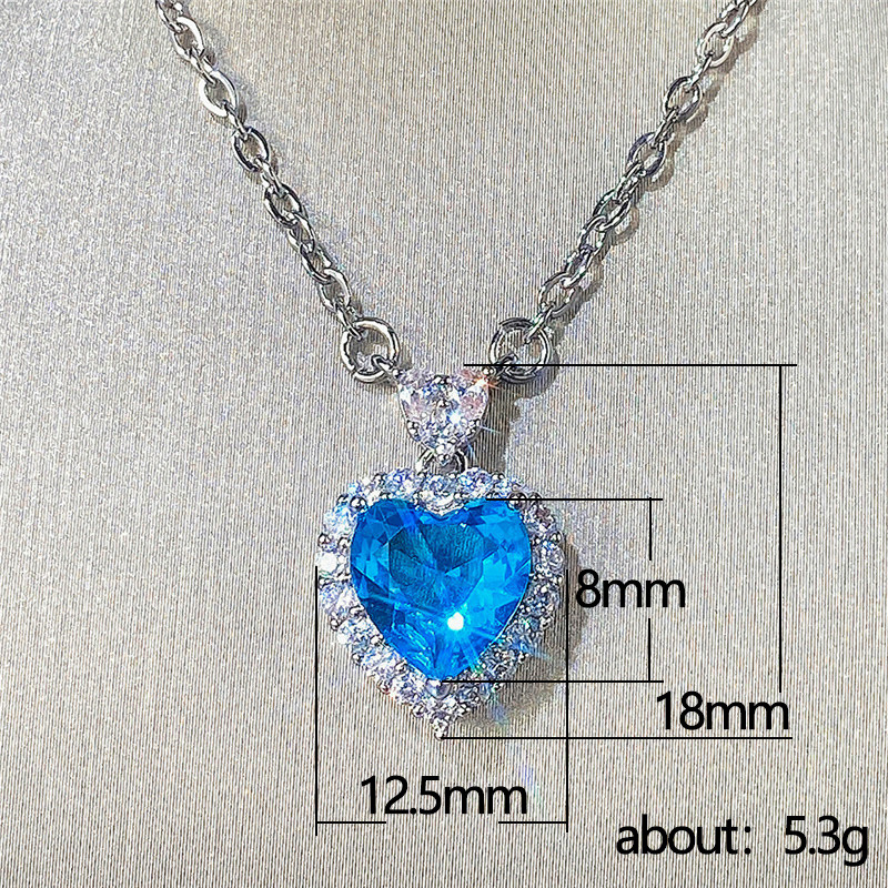 Conjunto de pendientes y anillo con colgante de corazón de océano con circonita azul topacio de nueva tendencia de Cao Shi Live para mujer_voghion.com