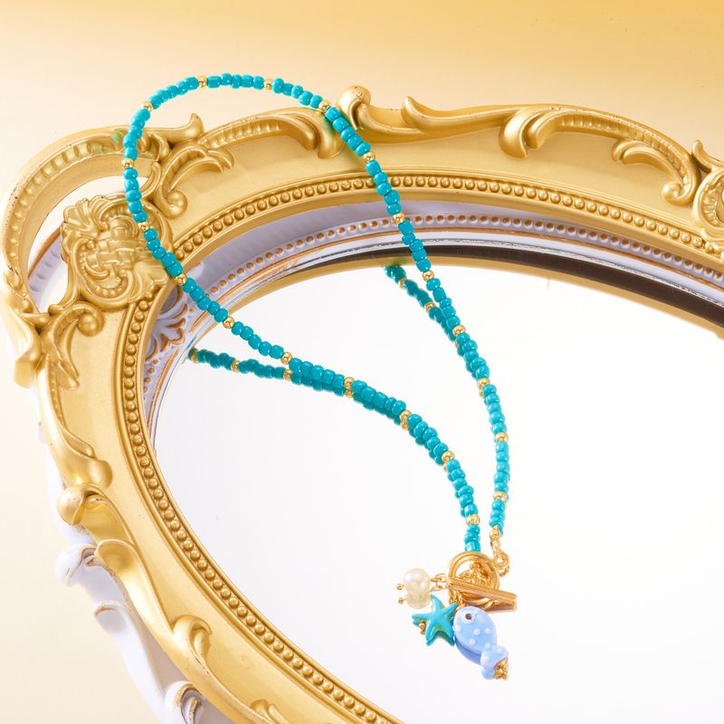 Nouveau collier double rang de perles de riz, pompon en céramique et fermoir OT, orné de petits poissons et d'étoiles de mer._voghion.com