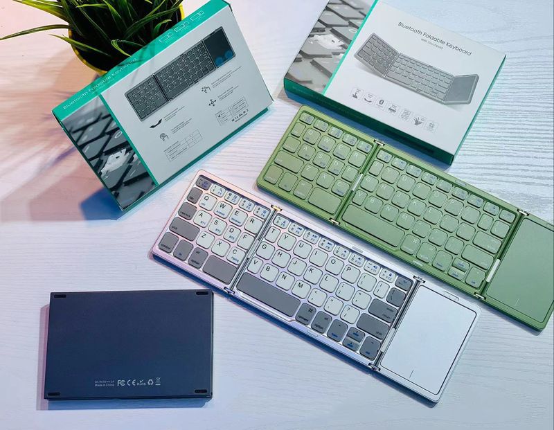 Draadloos opvouwbaar Bluetooth-toetsenbord Touch Mouse 64-toetsen draagbare universele tablettelefoon met drie systemen_voghion.com