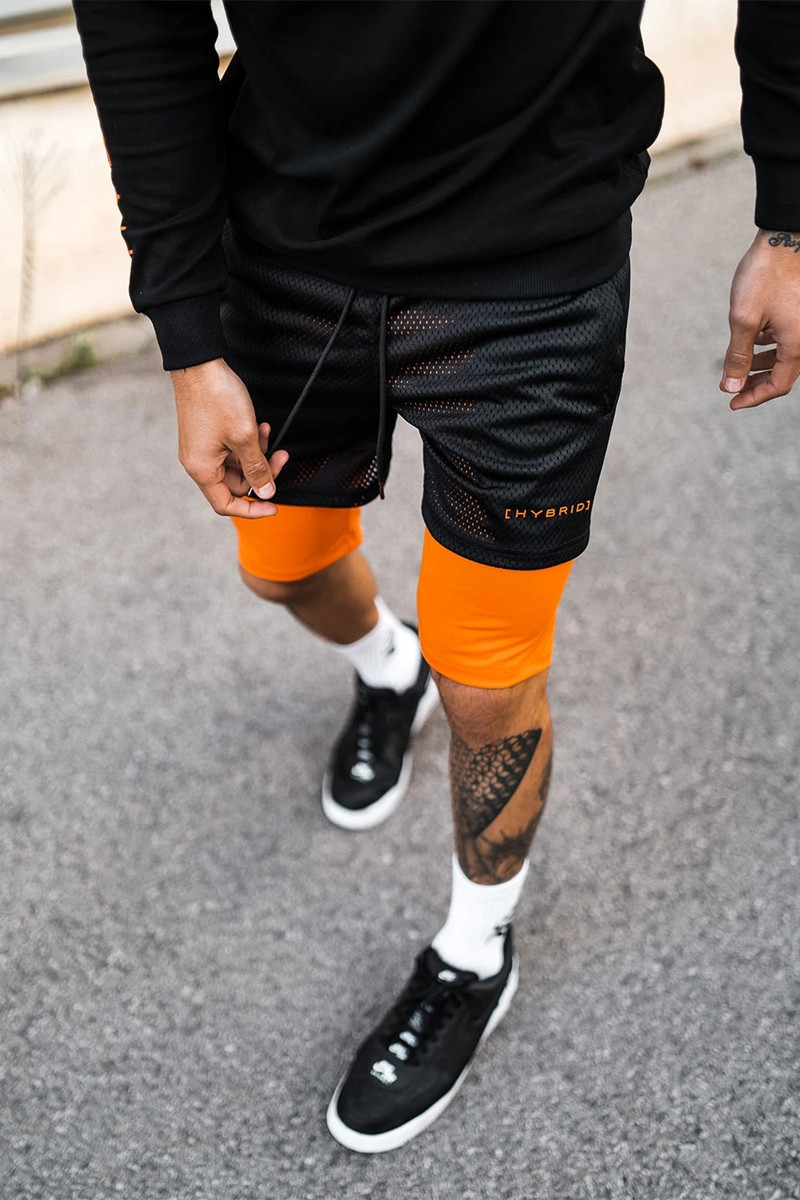 Pantaloncini sportivi alla moda a doppio strato per l'allenamento da uomo falso in due pezzi da basket in esecuzione fitness capris_voghion.com