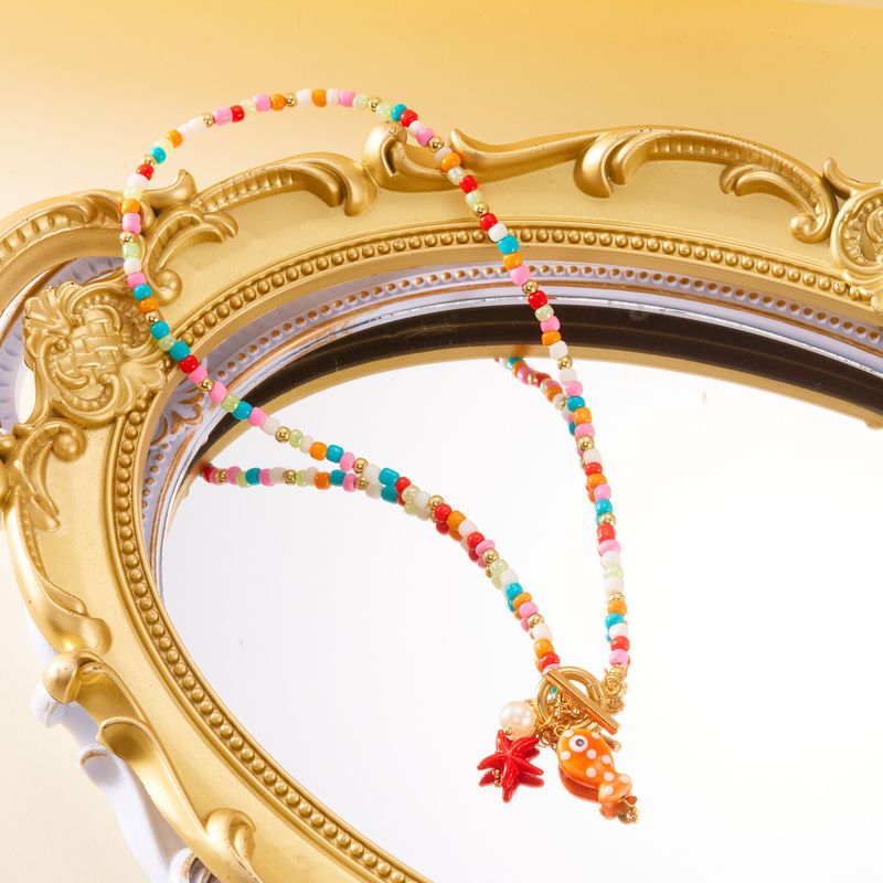 Nouveau collier double rang de perles de riz, pompon en céramique et fermoir OT, orné de petits poissons et d'étoiles de mer._voghion.com