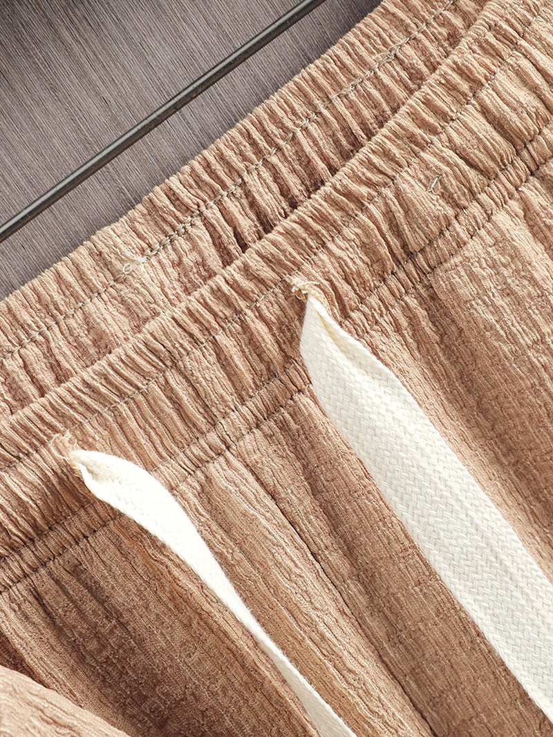 Un nuovo completo sportivo casual estivo da uomo europeo e americano con maniche corte e pantaloni lunghi in tinta unita, composto da due pezzi._voghion.com