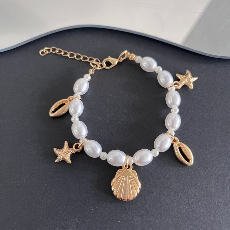 Bracciale da donna con conchiglia a forma di stella marina, in stile estivo, con perle irregolari e serie oceano, gioielli da spiaggia_voghion.com