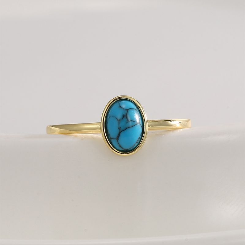 R0677 Anello in stile bohémien con turchese ovale intarsiato in oro per donna_voghion.com