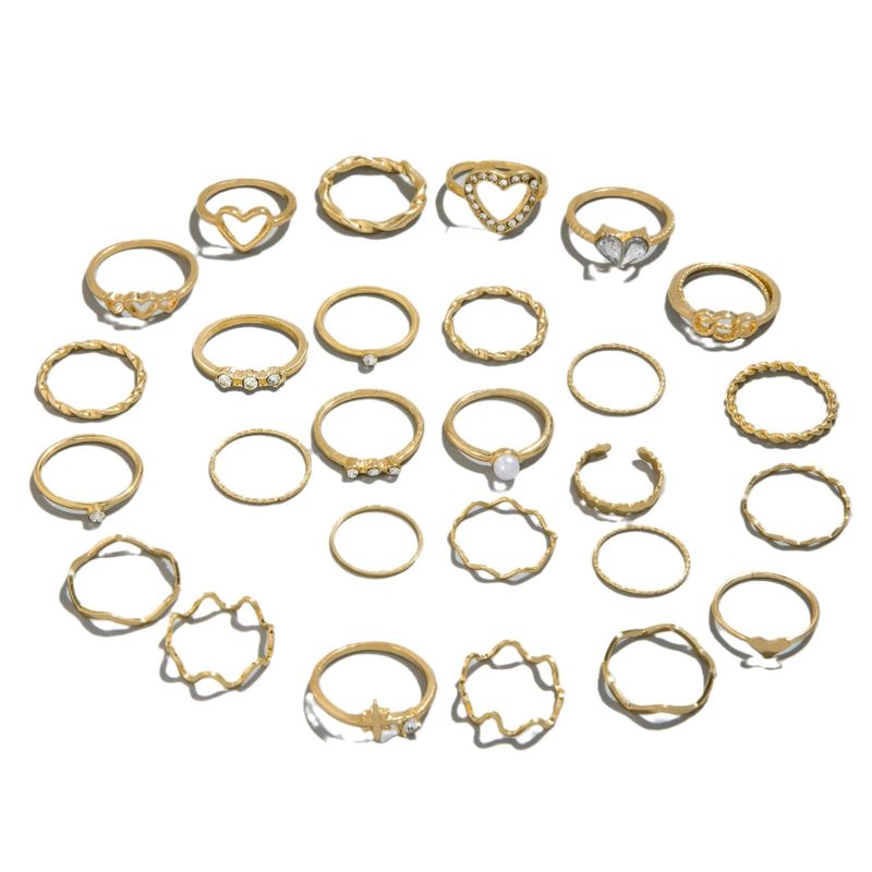 Anello a croce geometrica alla moda con cuore di diamanti intarsiato a vento e incastonato in più giunzioni_voghion.com