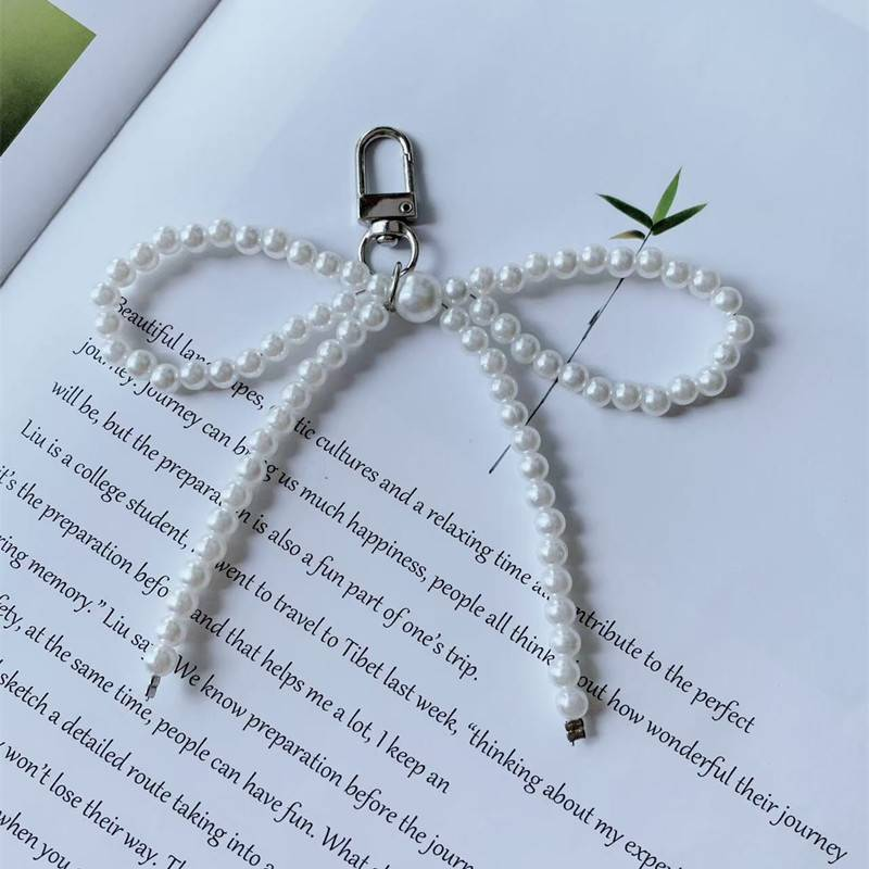 Parti e accessori per borse Nuovo ciondolo con fiocco di perle per ragazza dolce in argento Portachiavi con ciondolo con auricolare Bluetooth_voghion.com